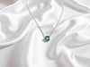 Delicate emerald birthstone pendant on 16-inch silver chain - May's stone of renewal