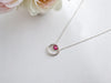 A bohemian-style, vintage-inspired sterling silver ruby hoop necklace