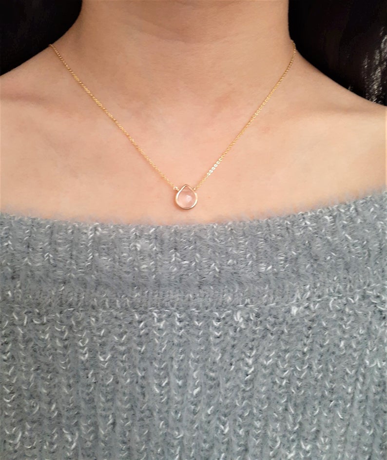 Gold necklace with tiny heart shape pendant and pink Zircons